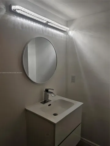a bathroom with a sink and mirror