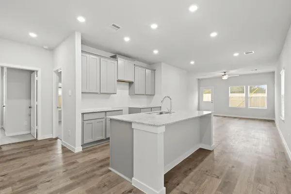 a kitchen with white cabinets appliances and a sink