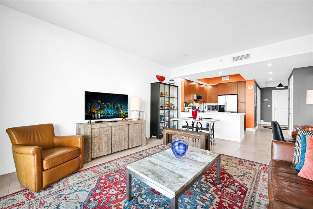 315 Northeast 3rd Avenue, Unit 1008 Fort Lauderdale, FL 33301 - Photo 14 of 52 a living room with furniture and a flat screen tv