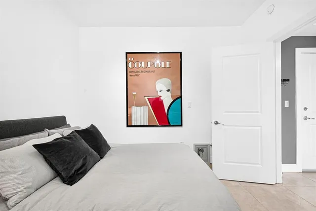 a picture of a bedroom with a bed and wall painting