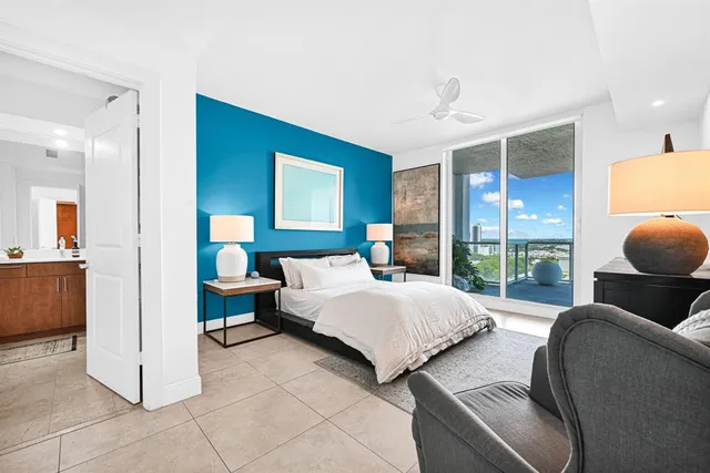 a bedroom with a bed and large window