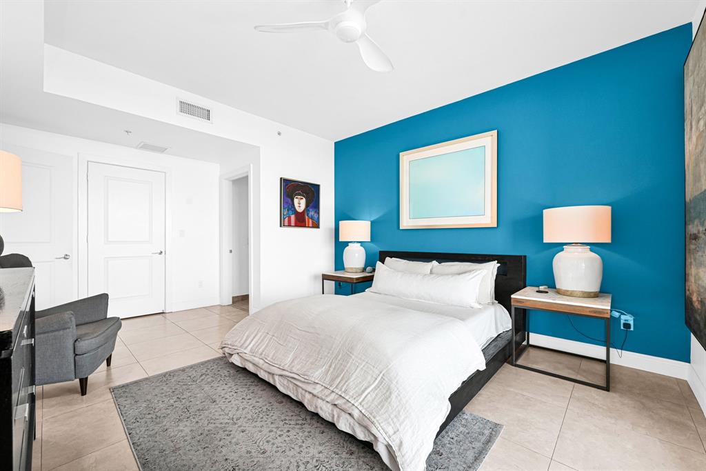 315 Northeast 3rd Avenue, Unit 1008 Fort Lauderdale, FL 33301 - Photo 18 of 52 a bedroom with a bed and a lamp on table