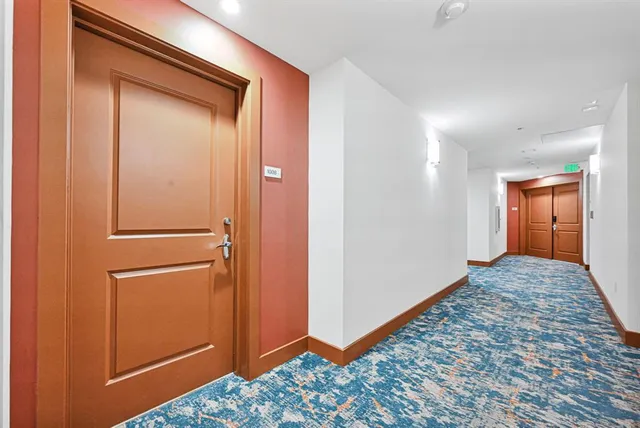 a view of hallway with a dresser and mirror