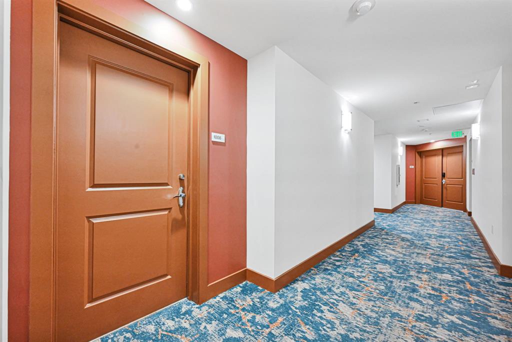 315 Northeast 3rd Avenue, Unit 1008 Fort Lauderdale, FL 33301 - Photo 2 of 52 a view of hallway with a dresser and mirror
