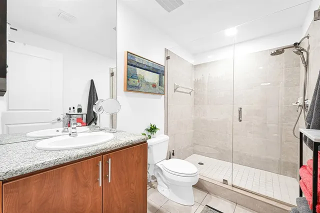 a bathroom with a sink a toilet and shower