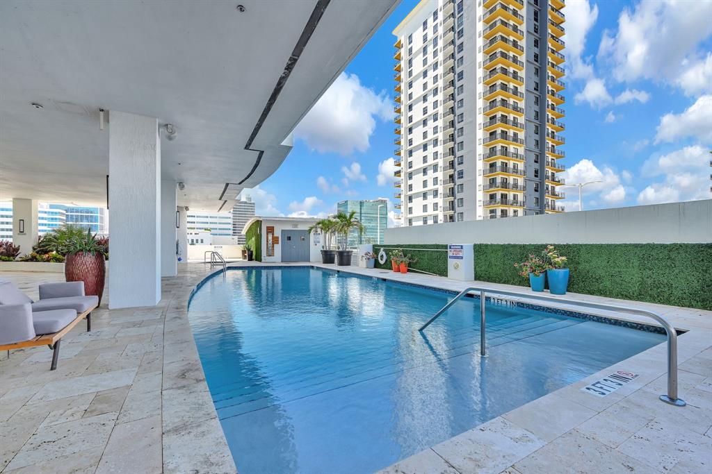 315 Northeast 3rd Avenue, Unit 1008 Fort Lauderdale, FL 33301 - Photo 39 of 52 a view of a swimming pool with a lounge chairs
