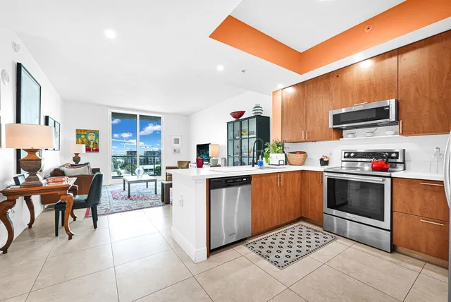 a kitchen with stainless steel appliances kitchen island granite countertop a sink and cabinets