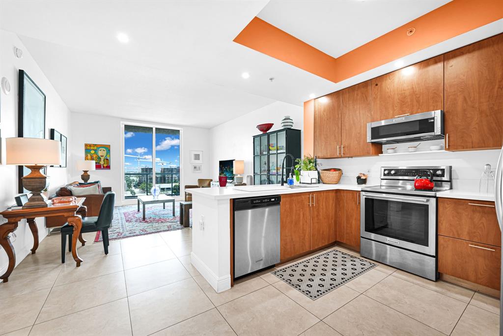 315 Northeast 3rd Avenue, Unit 1008 Fort Lauderdale, FL 33301 - Photo 4 of 52 a kitchen with stainless steel appliances kitchen island granite countertop a sink and cabinets