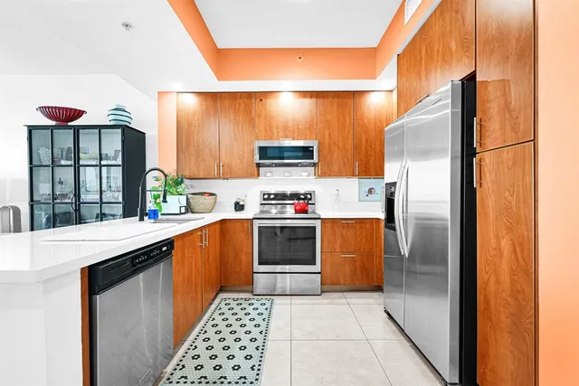 a kitchen with stainless steel appliances a refrigerator and a stove