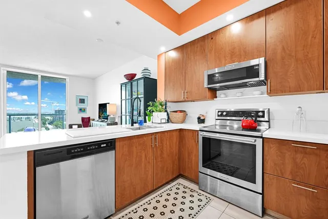 a kitchen with stainless steel appliances a sink cabinets and a counter top space