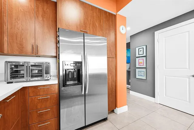 a kitchen with stainless steel appliances granite countertop a refrigerator and a stove