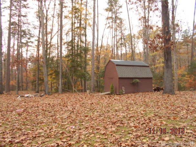 580 Manchester Road Mount Gilead, NC 27306 - Photo 12 of 13 a backyard of a house with large trees