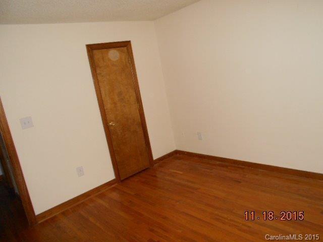 580 Manchester Road Mount Gilead, NC 27306 - Photo 3 of 13 an empty room with wooden floor