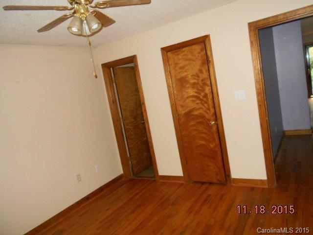 580 Manchester Road Mount Gilead, NC 27306 - Photo 6 of 13 an empty room with wooden floor and windows