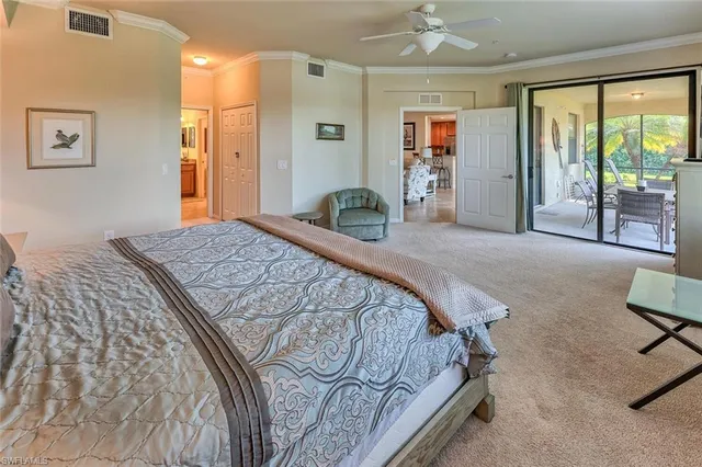 a bedroom with a bed and glass walk in closet