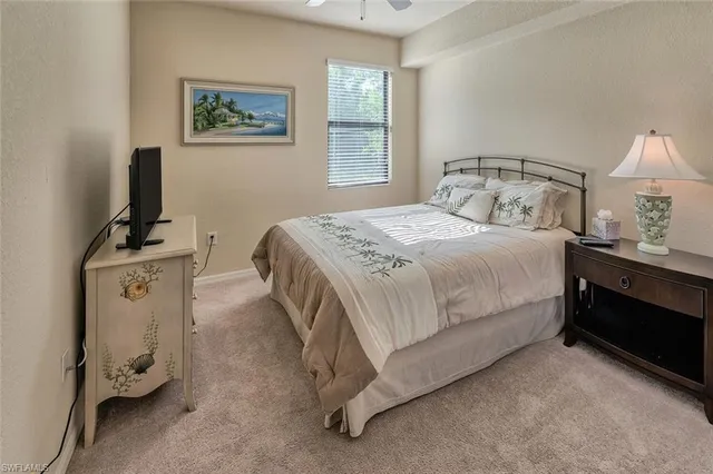 a bedroom with a bed and a lamp on table
