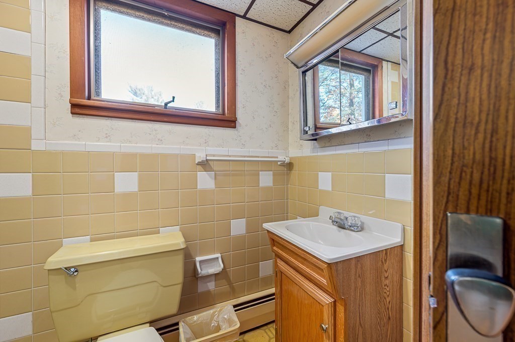 24 Second Street Worcester, MA 01602 - Photo 19 of 42 a bathroom with a sink a toilet and a mirror