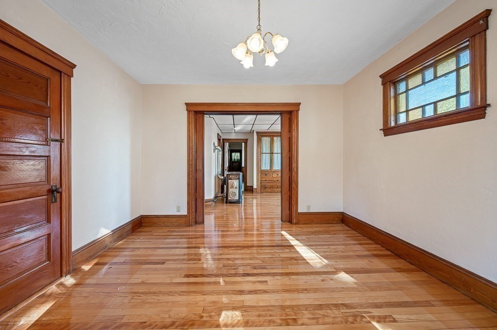 24 Second Street Worcester, MA 01602 - Photo 23 of 42 a view of a hallway with wooden floor and a chandelier