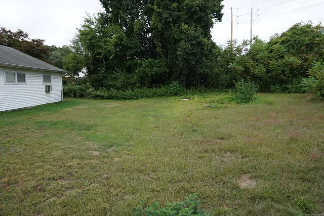 a view of a yard with a house in the background