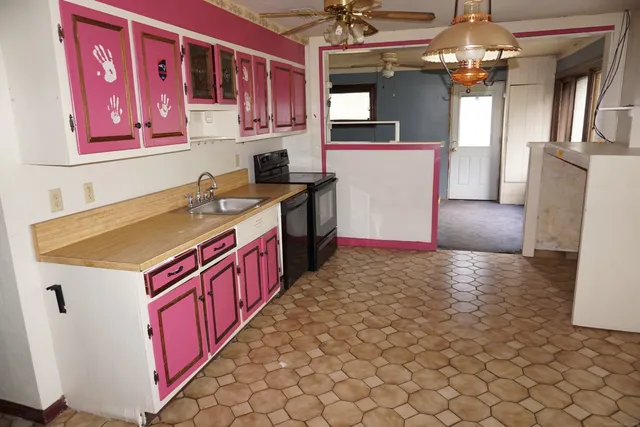 a kitchen with a sink stove and refrigerator