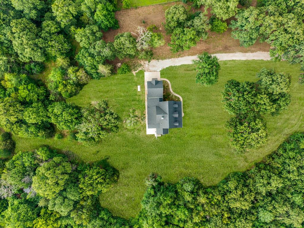 1037 Harrison Road Denison, TX 75021 - Photo 37 of 39 Aerial property overview showcasing a central residence with a dark-pitched roof and a light-colored driveway
