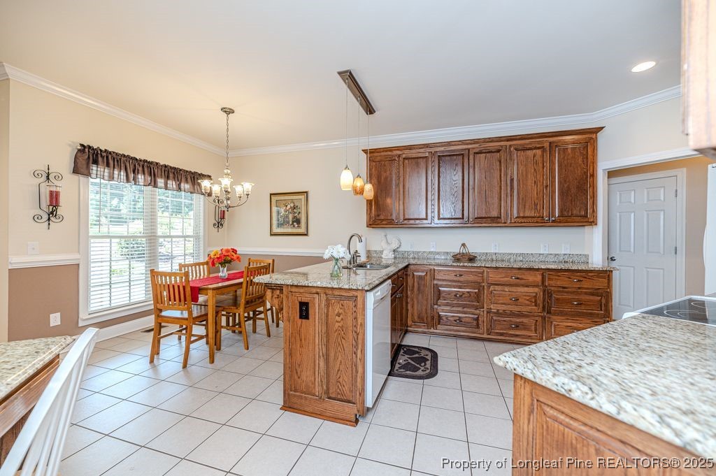 4635 Farrell Road Sanford, NC 27330 - Photo 9 of 30 a kitchen with kitchen island granite countertop wooden cabinets a dining table and chairs