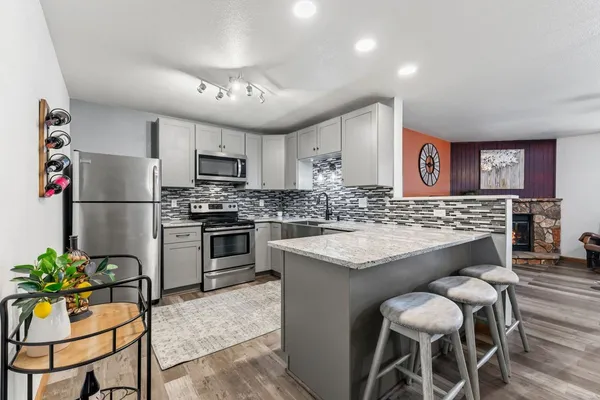 a kitchen with cabinets and stainless steel appliances