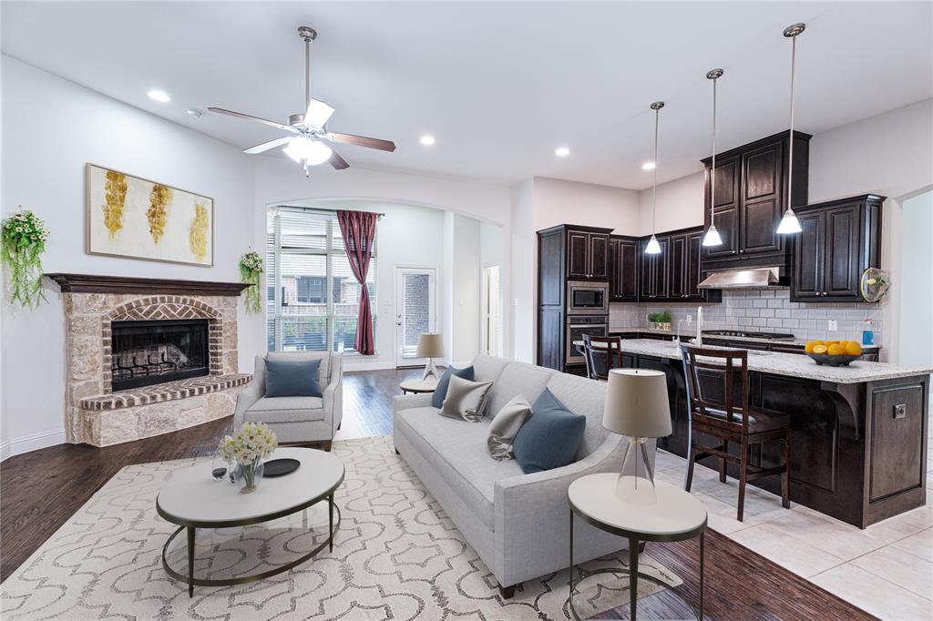 a living room with furniture a table and kitchen view