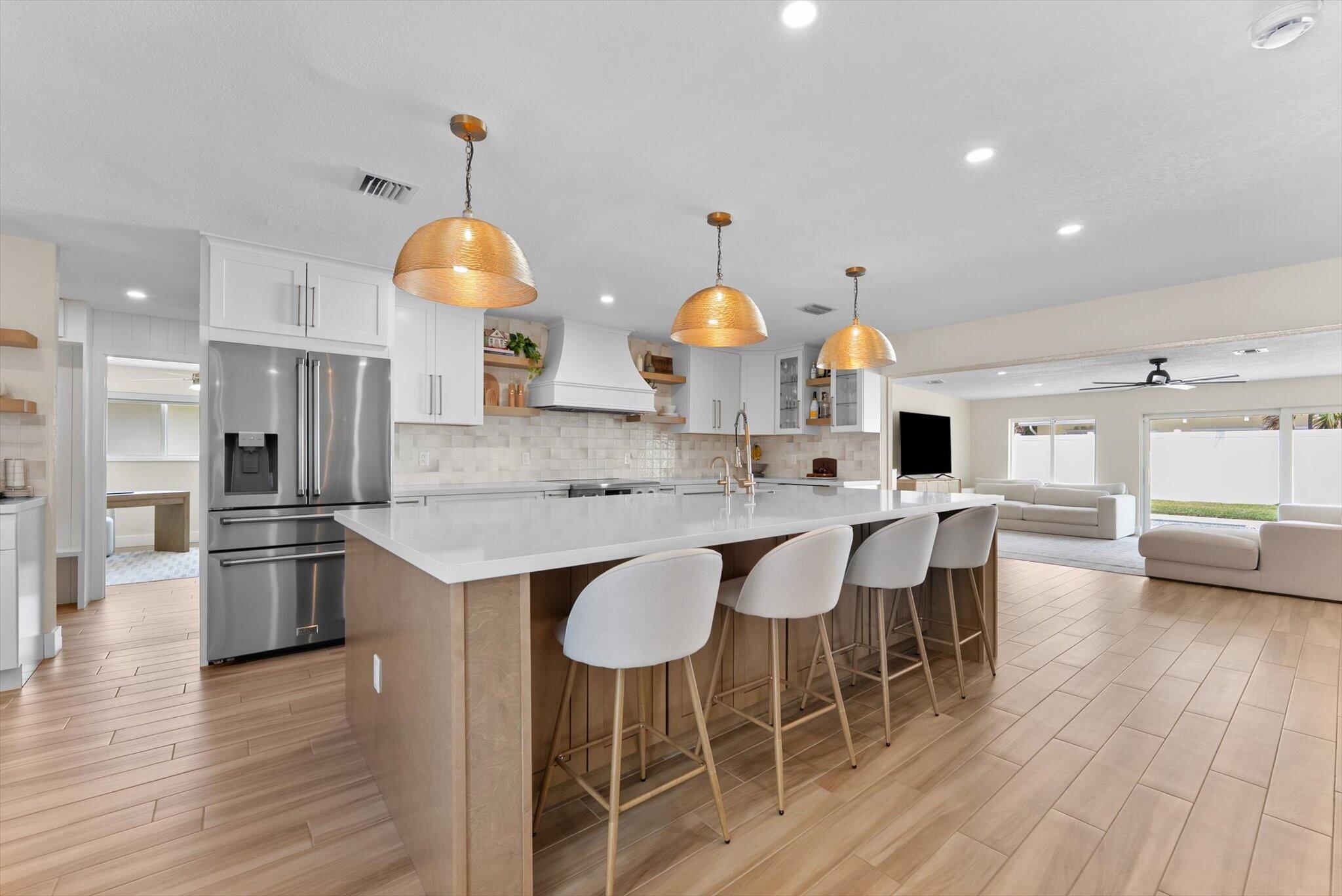 1289 Southwest 7th Street Boca Raton, FL 33486 - Photo 11 of 42 a kitchen with stainless steel appliances granite countertop a sink a stove and a refrigerator