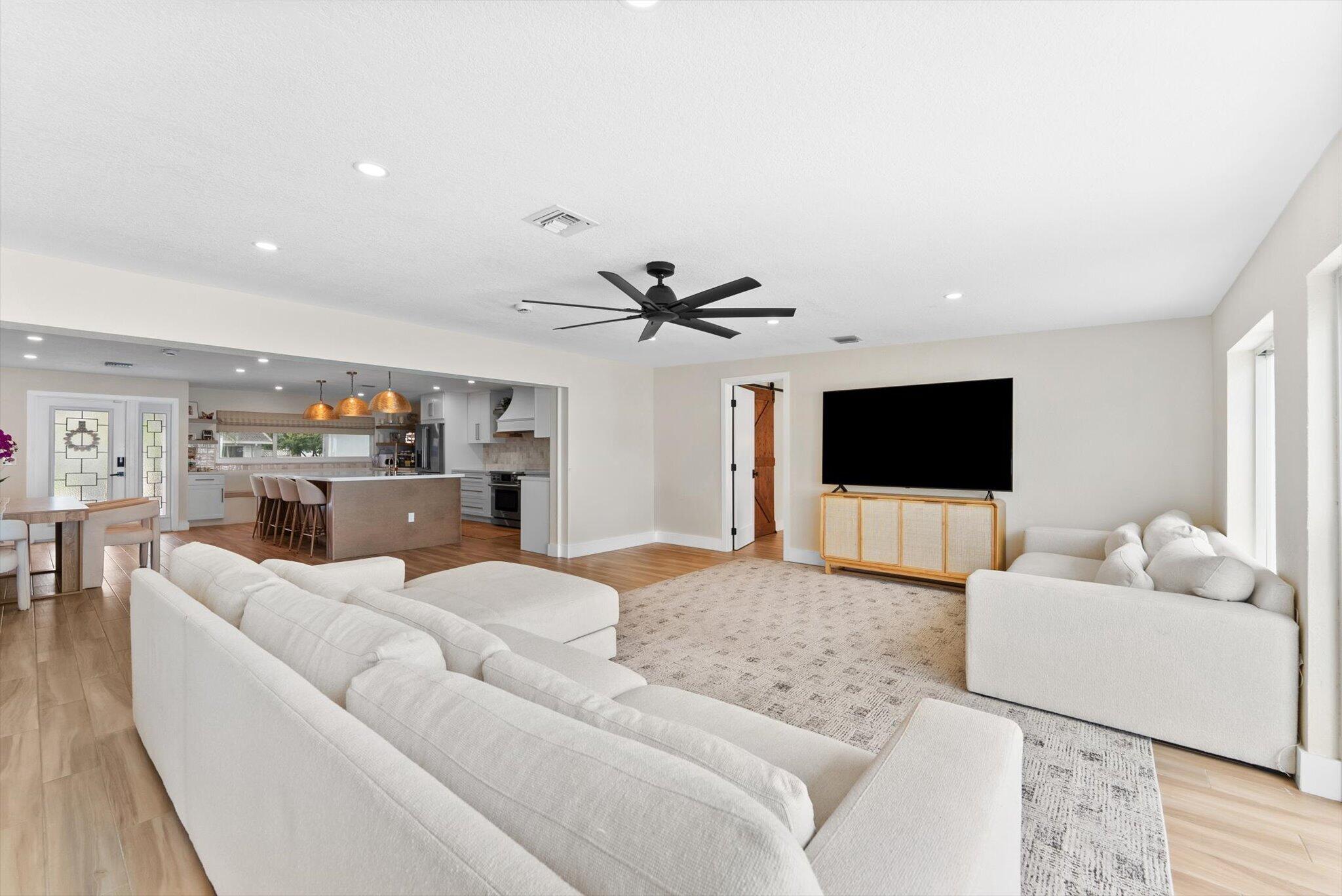 1289 Southwest 7th Street Boca Raton, FL 33486 - Photo 12 of 42 a living room with furniture and a flat screen tv