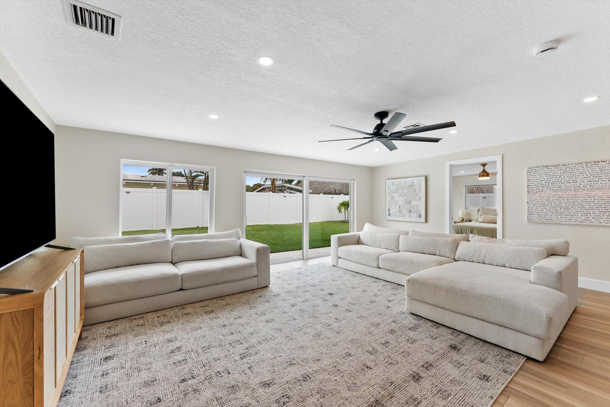 1289 Southwest 7th Street Boca Raton, FL 33486 - Photo 13 of 42 a living room with furniture and a flat screen tv