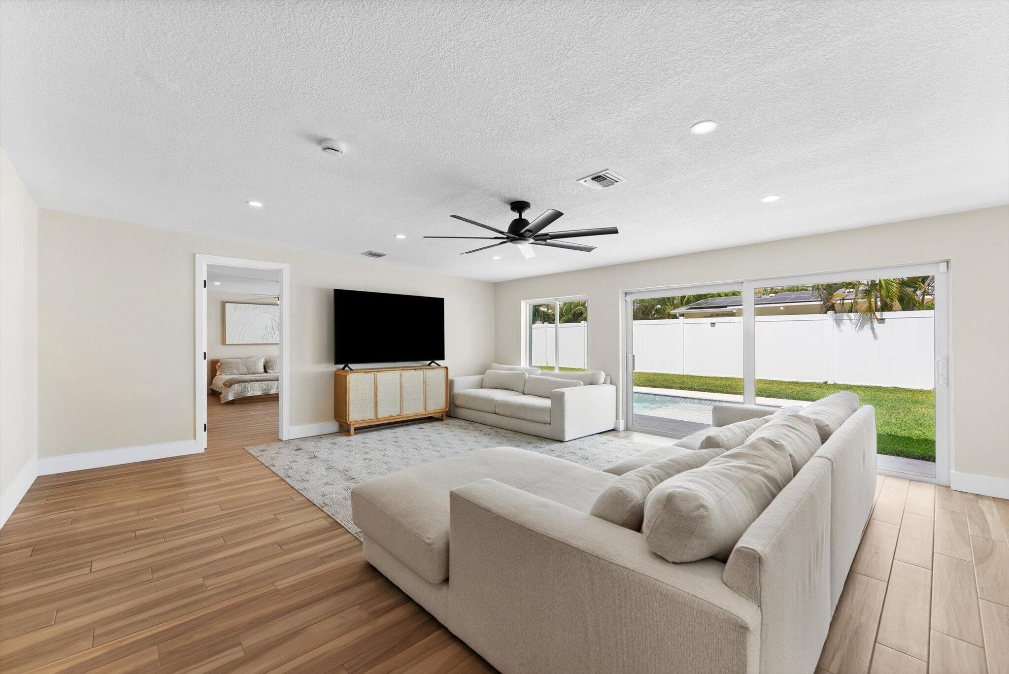 1289 Southwest 7th Street Boca Raton, FL 33486 - Photo 14 of 42 a living room with furniture and a flat screen tv