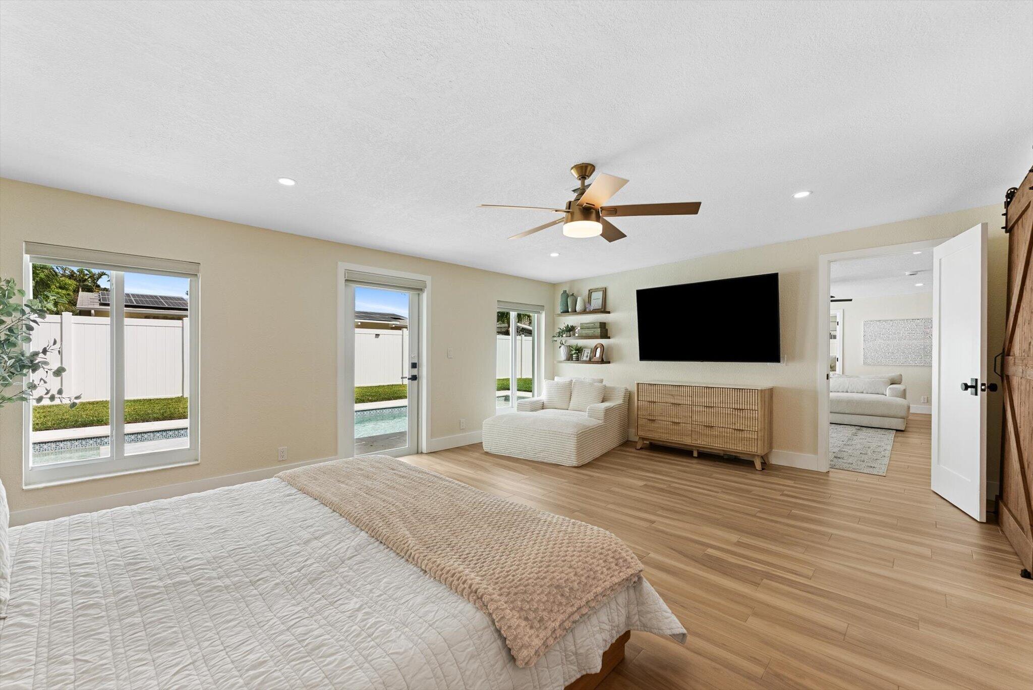 1289 Southwest 7th Street Boca Raton, FL 33486 - Photo 15 of 42 a bedroom with a bed and a flat screen tv