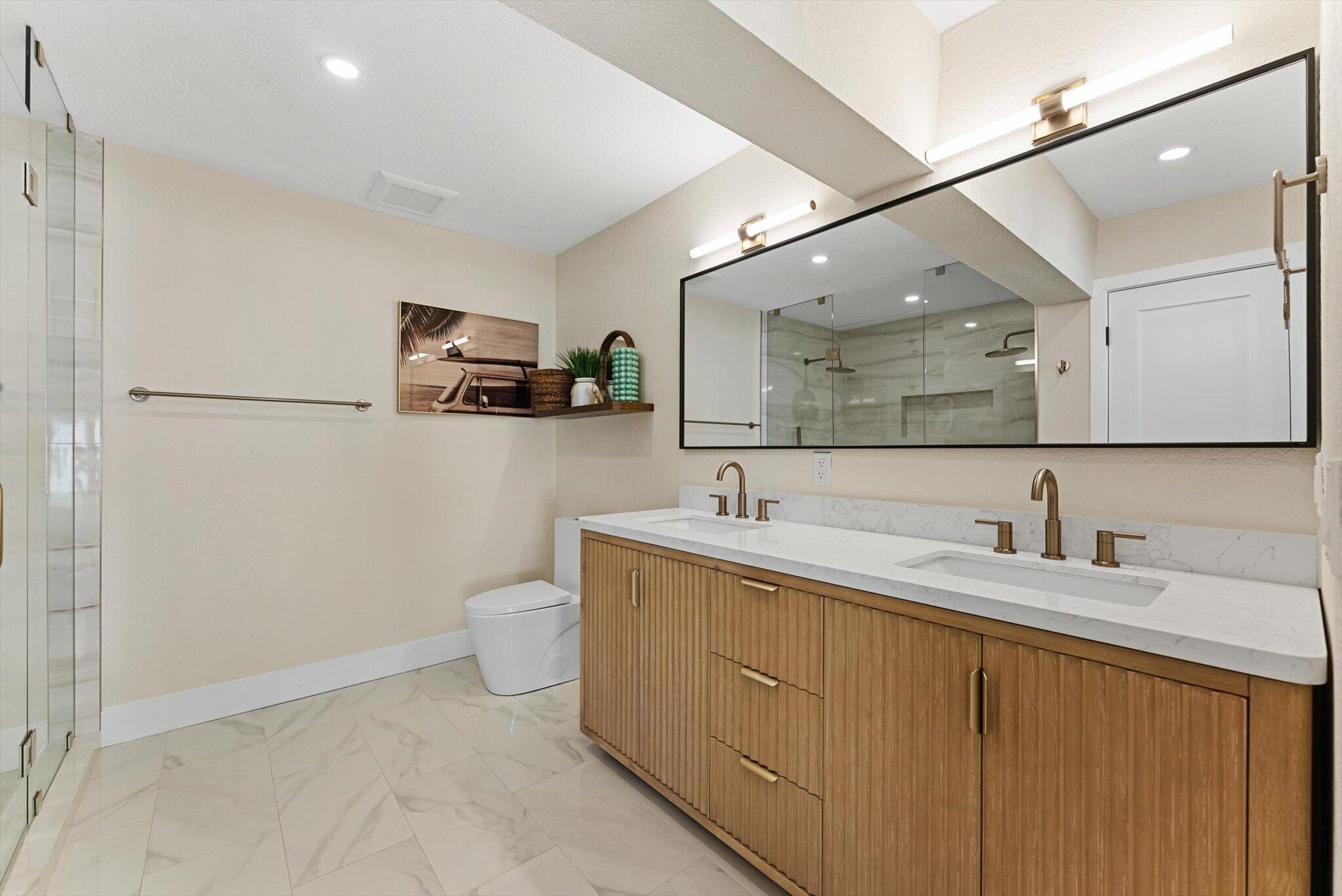 1289 Southwest 7th Street Boca Raton, FL 33486 - Photo 18 of 42 a bathroom with a toilet sink and mirror