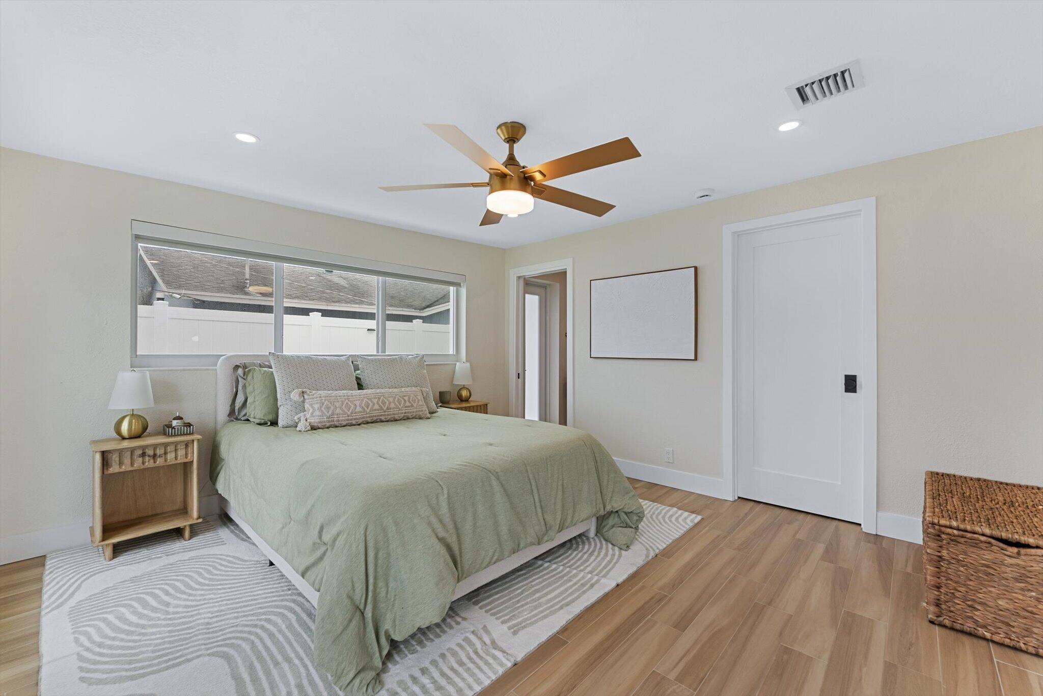 1289 Southwest 7th Street Boca Raton, FL 33486 - Photo 20 of 42 a bedroom with a bed and a chandelier