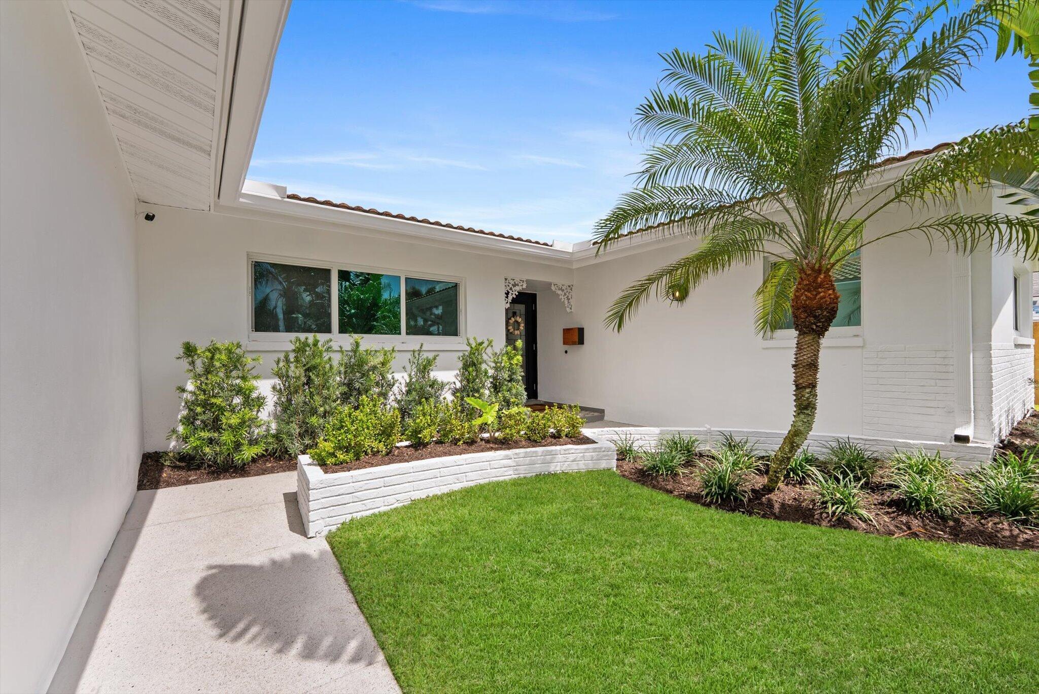 1289 Southwest 7th Street Boca Raton, FL 33486 - Photo 2 of 42 a view of a house with a garden