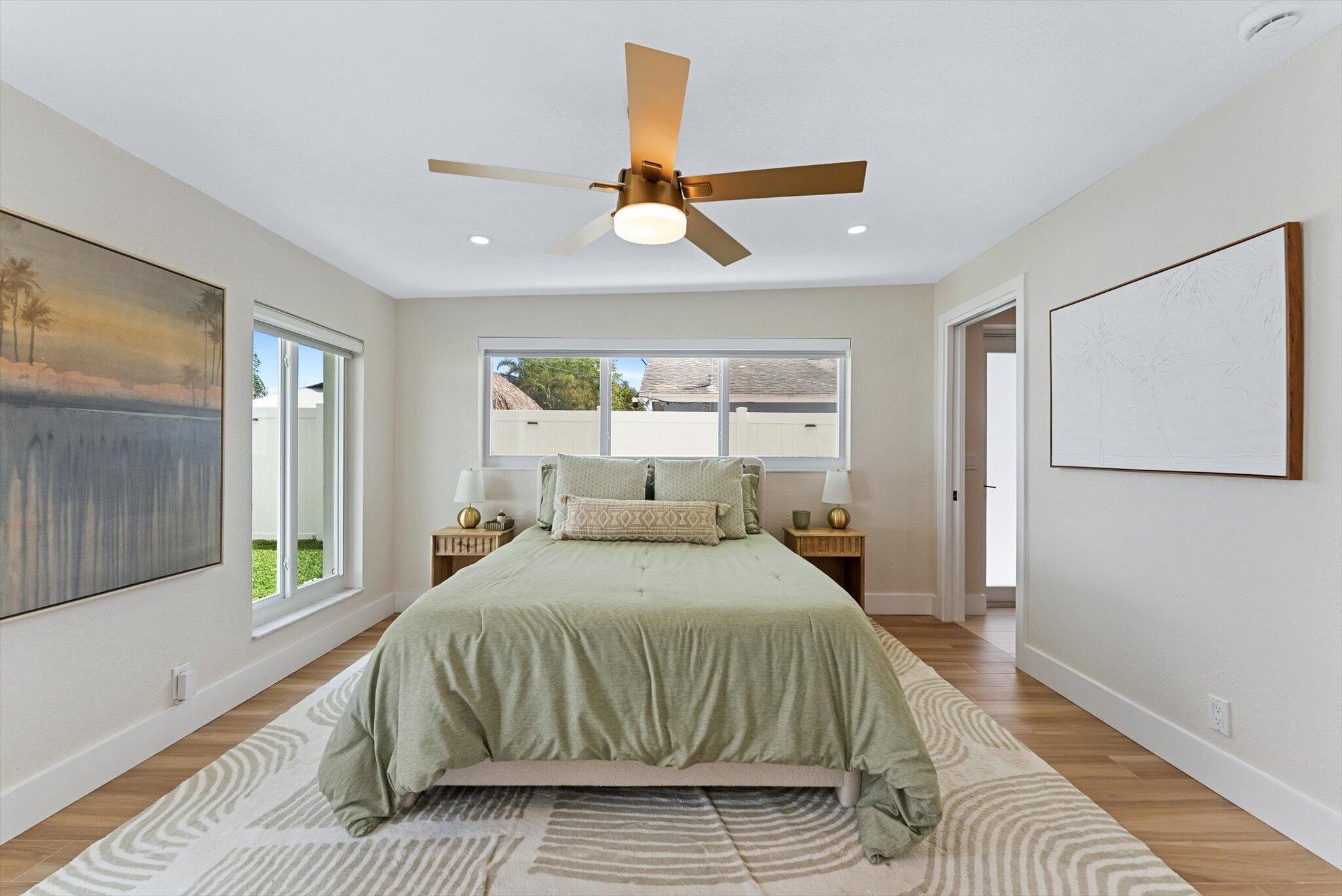 1289 Southwest 7th Street Boca Raton, FL 33486 - Photo 21 of 42 a bedroom with a bed and a large window