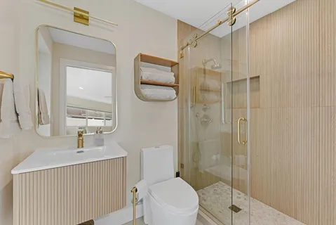 a bathroom with a toilet a sink and shower