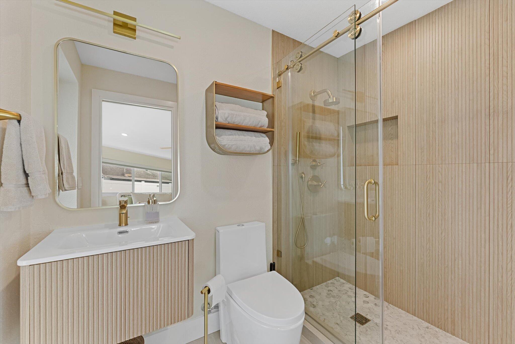 1289 Southwest 7th Street Boca Raton, FL 33486 - Photo 23 of 42 a bathroom with a toilet a sink and shower