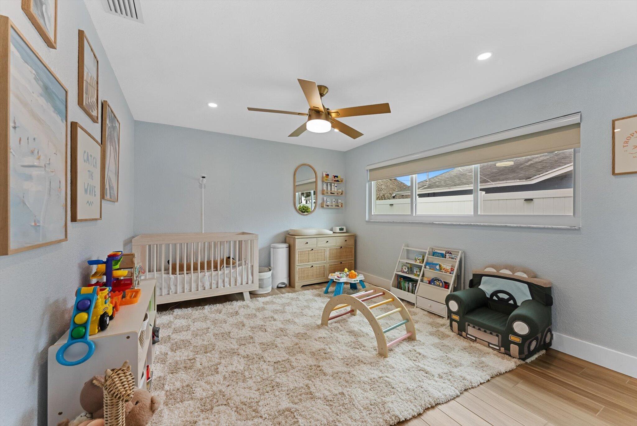 1289 Southwest 7th Street Boca Raton, FL 33486 - Photo 28 of 42 a bedroom with furniture and a window