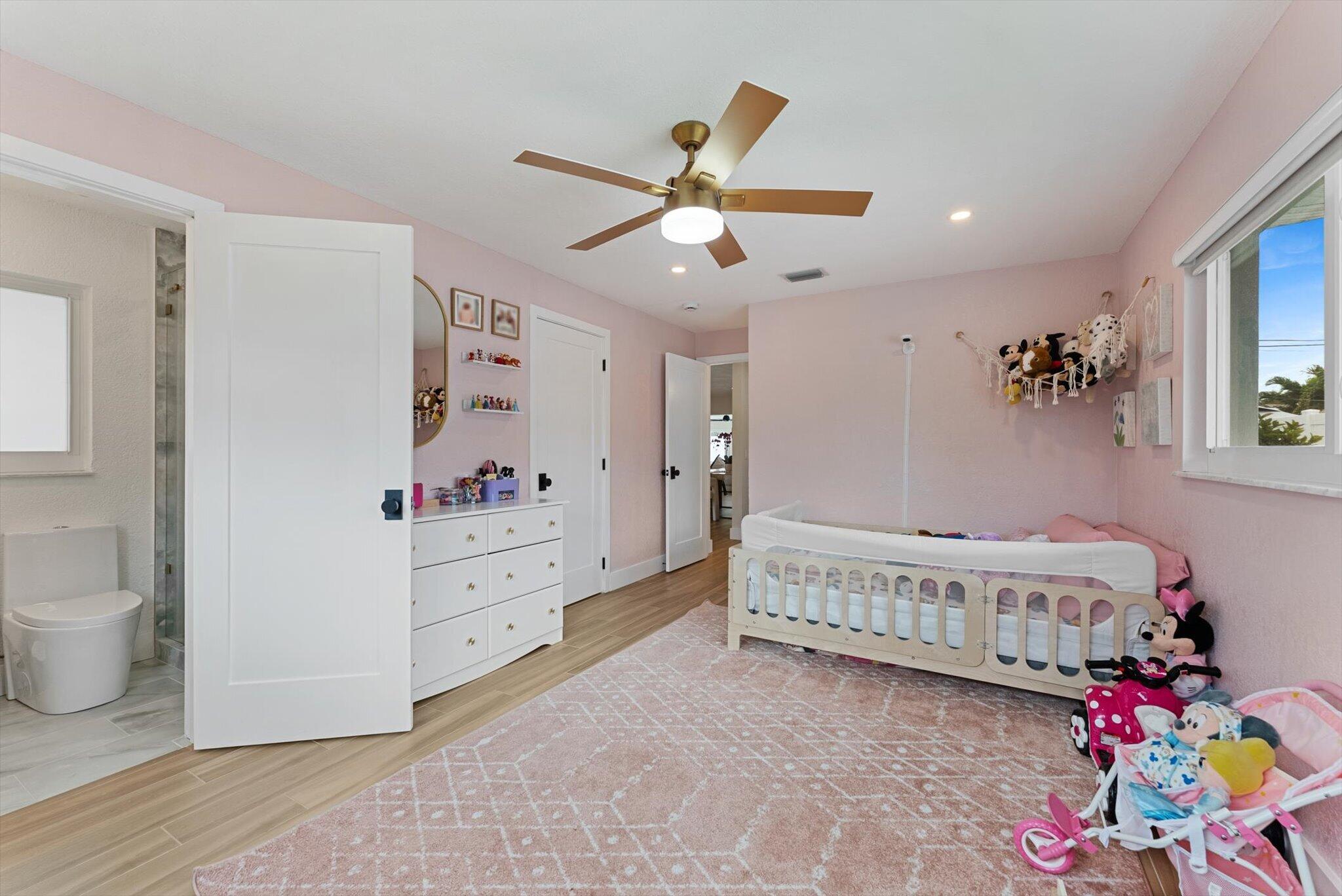 1289 Southwest 7th Street Boca Raton, FL 33486 - Photo 31 of 42 a living room with baby crib furniture and a window