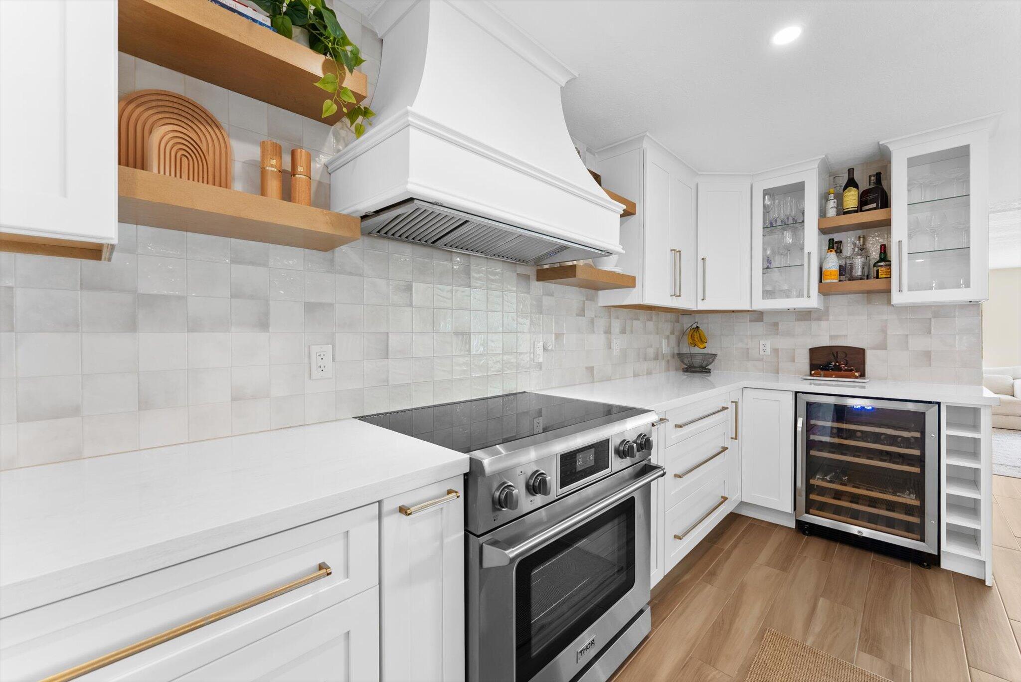 1289 Southwest 7th Street Boca Raton, FL 33486 - Photo 9 of 42 a kitchen with a stove cabinets and wooden floor