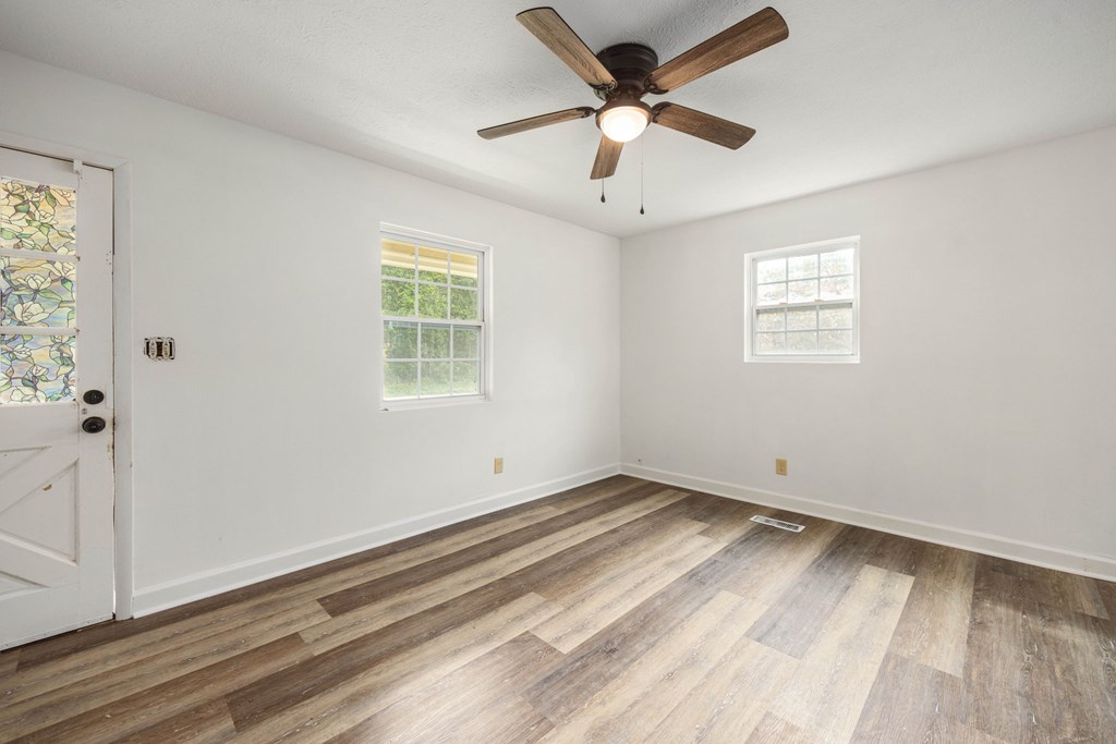 246 Sunnyside Church Road Pine Mountain, GA 31822 - Photo 9 of 26 a view of a big room with wooden floor and windows