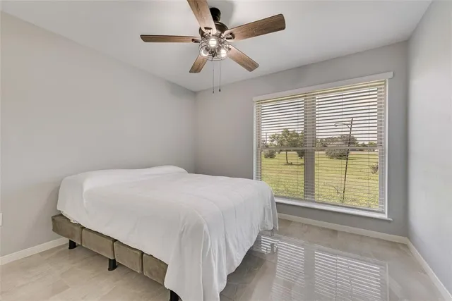 a bedroom with a large bed and a large window