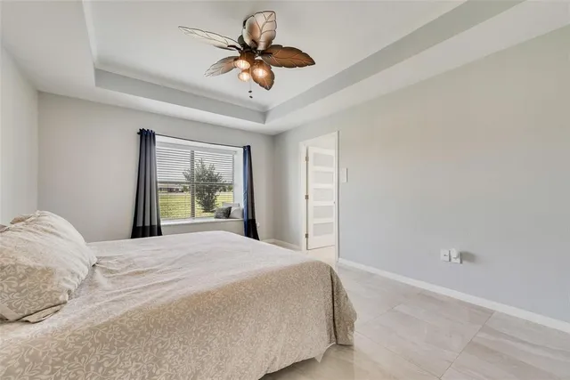 a bedroom with a large bed and a chandelier