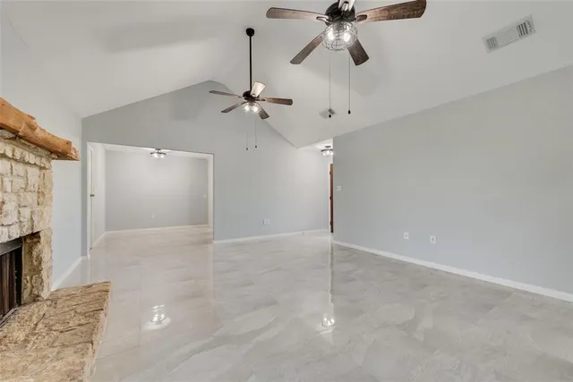 a view of an empty room with a fireplace