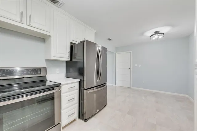 a kitchen with cabinets and stainless steel appliances