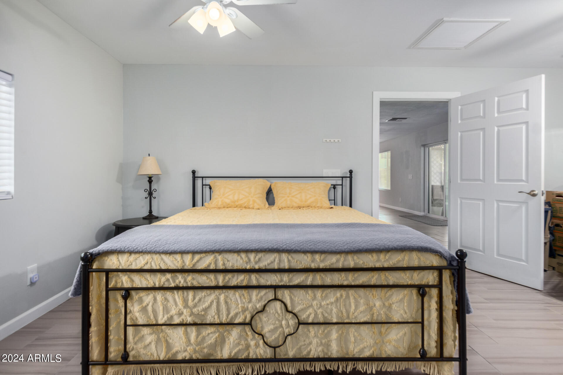 3216 West Hearn Road Phoenix, AZ 85053 - Photo 15 of 32 a bedroom with a bed and a chandelier