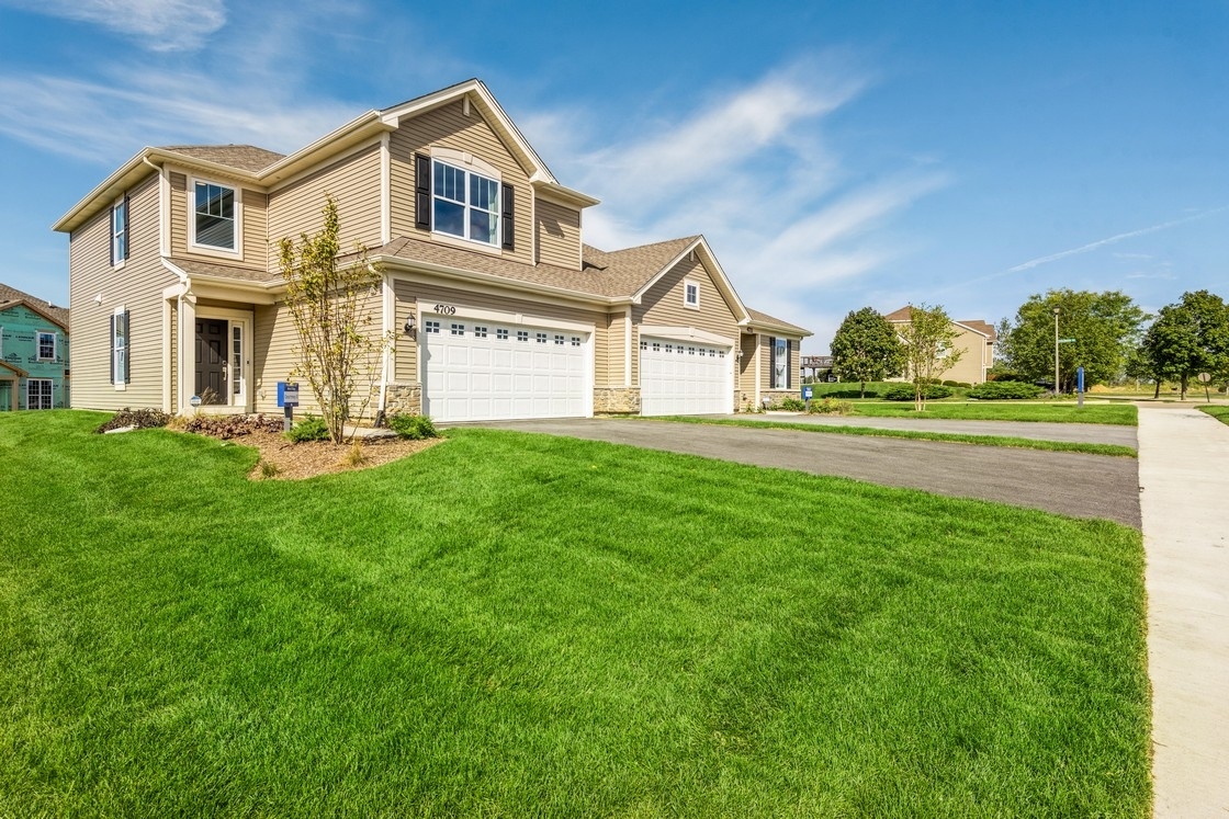 8528 Stillwater Road Wonder Lake, IL 60097 - Photo 1 of 28 a front view of a house with a yard and trees