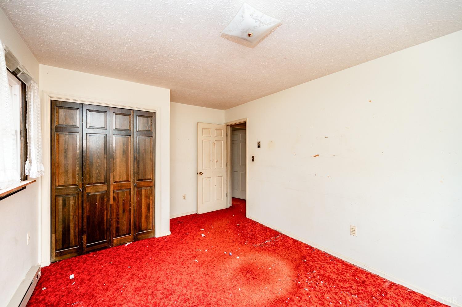 182 Buffalo Ridge Road Amherst, VA 24521 - Photo 14 of 57 a bedroom with a bed and a dresser